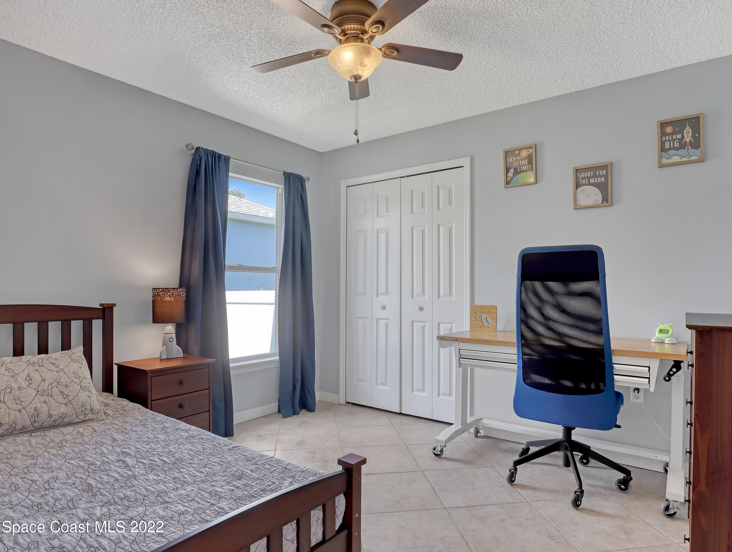 4920 Spinet Drive Melbourne, FL 32940 - Photo 22 of 44 a bedroom with a bed and a chandelier