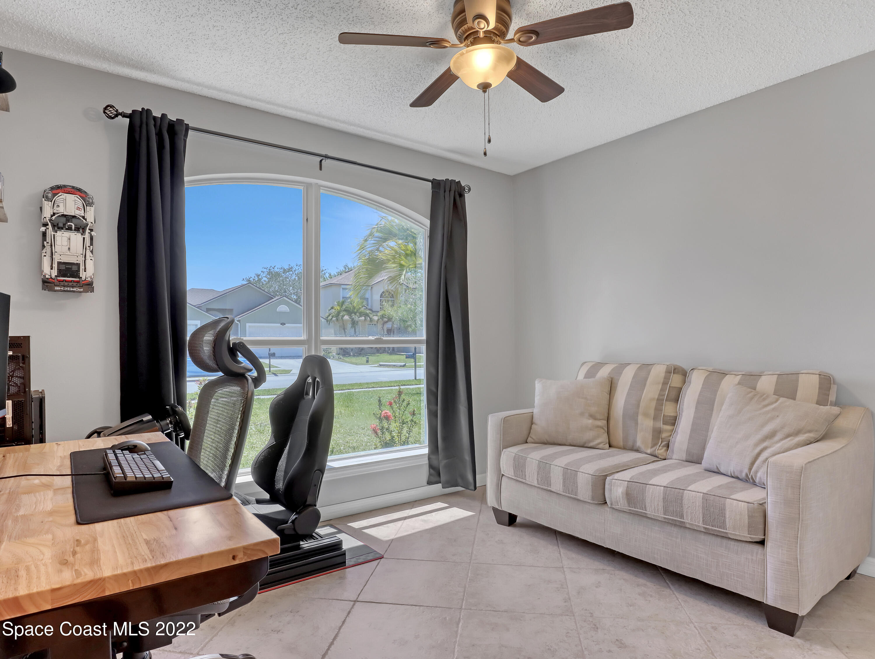 4920 Spinet Drive Melbourne, FL 32940 - Photo 23 of 44 a living room with furniture a ceiling fan and a window