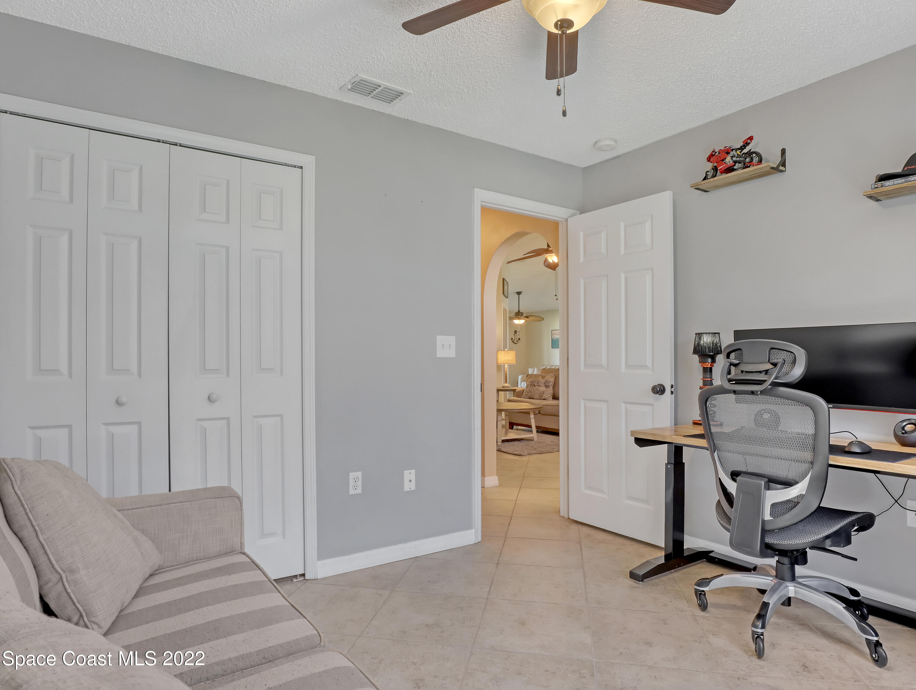 4920 Spinet Drive Melbourne, FL 32940 - Photo 24 of 44 a view of a livingroom with workspace and a couch