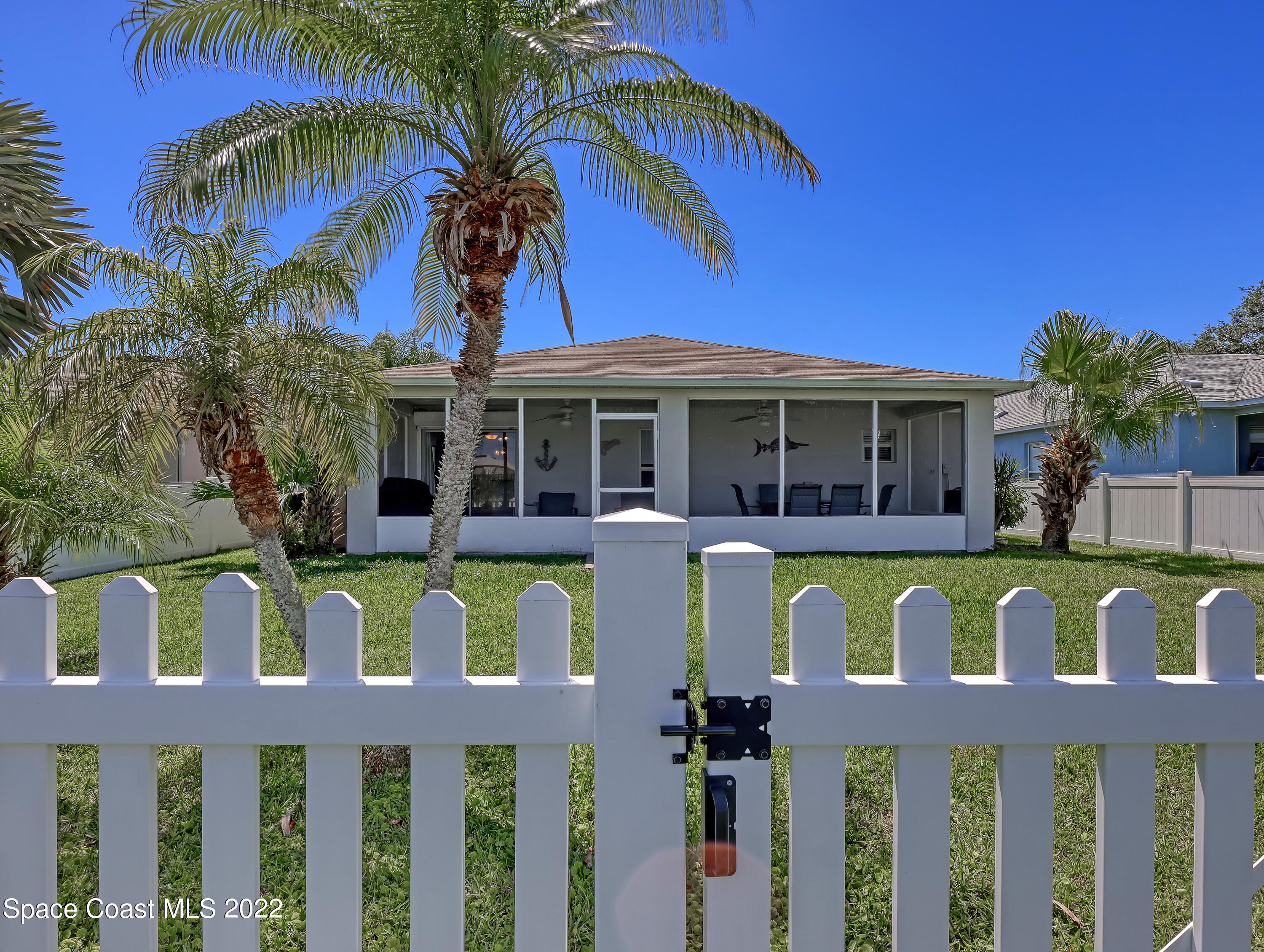 4920 Spinet Drive Melbourne, FL 32940 - Photo 30 of 44 a front view of a house with a garden