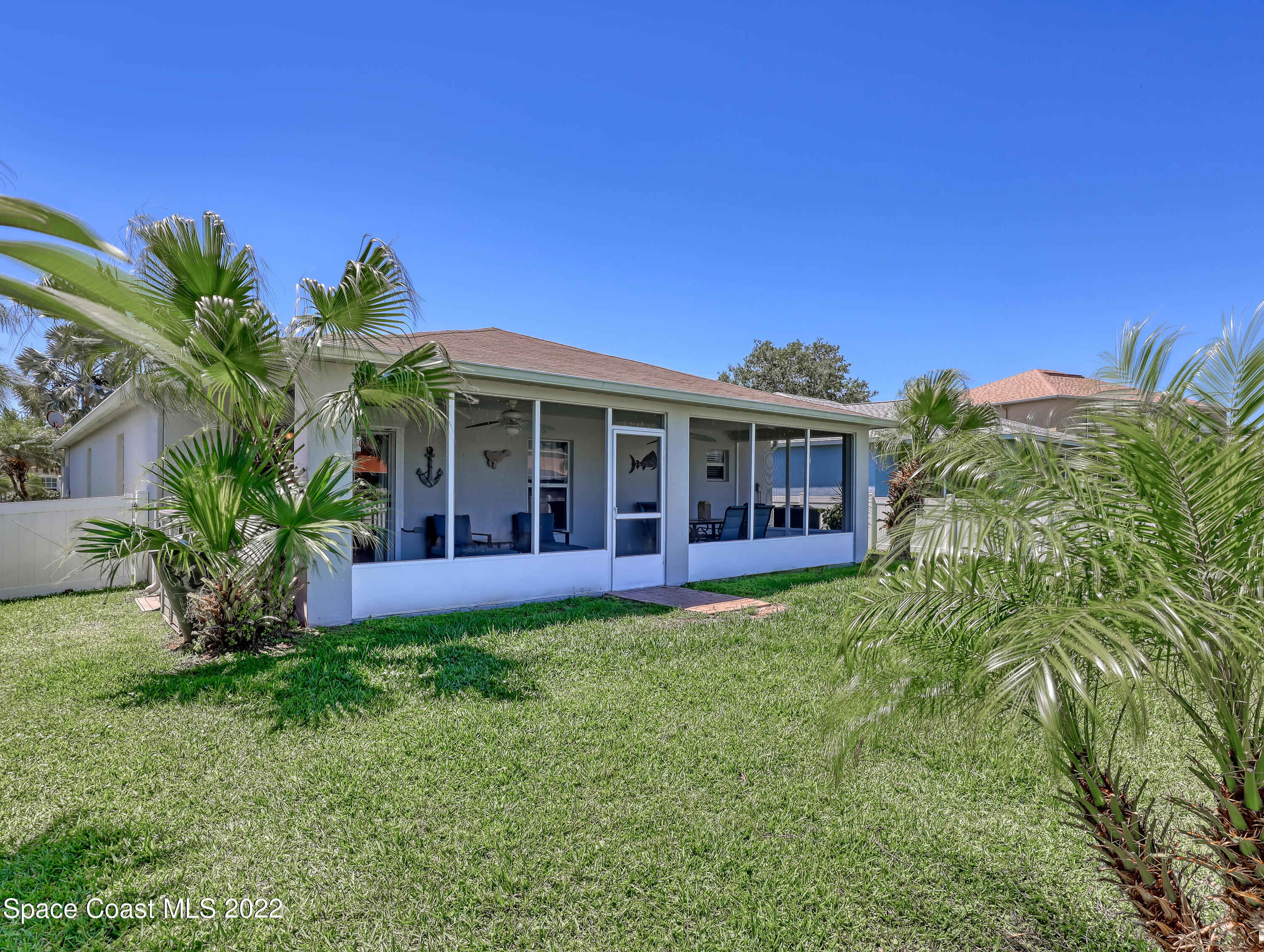 4920 Spinet Drive Melbourne, FL 32940 - Photo 33 of 44 a view of a house with a yard and potted plants