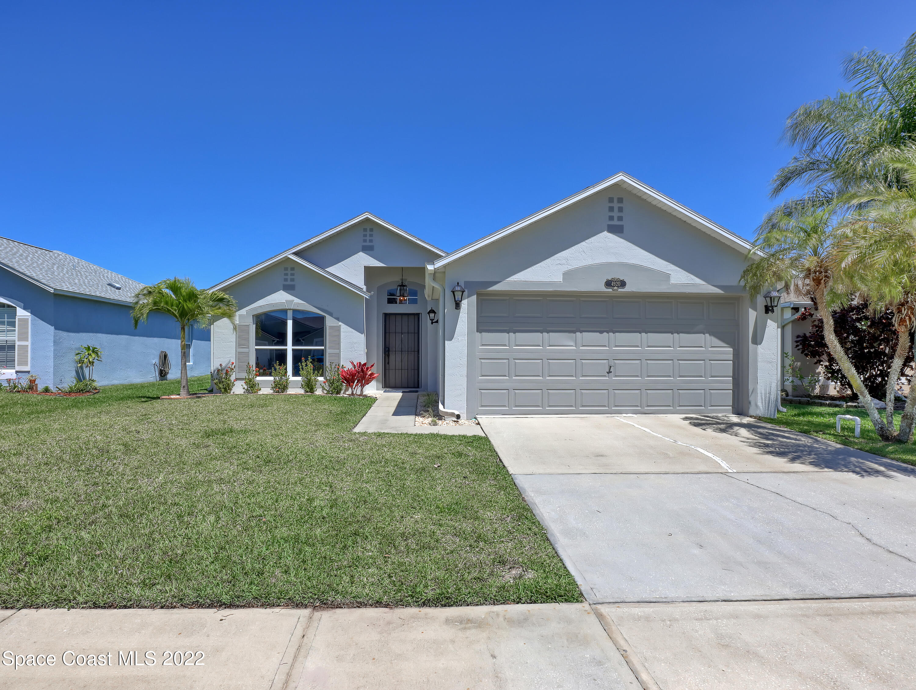 4920 Spinet Drive Melbourne, FL 32940 - Photo 36 of 44 a front view of a house with a yard