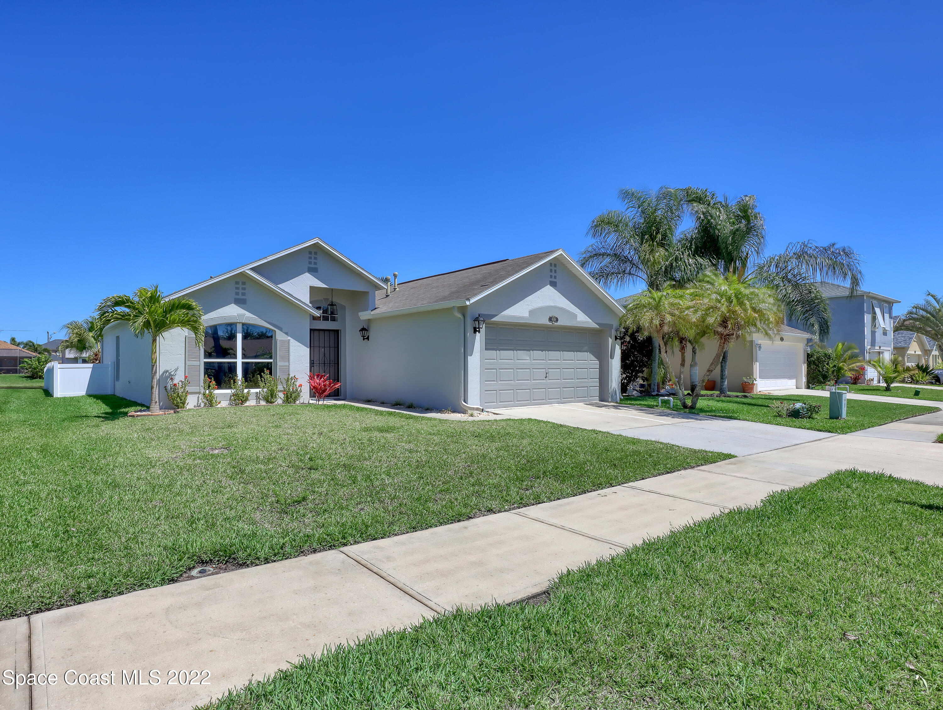 4920 Spinet Drive Melbourne, FL 32940 - Photo 37 of 44 a front view of a house with a yard