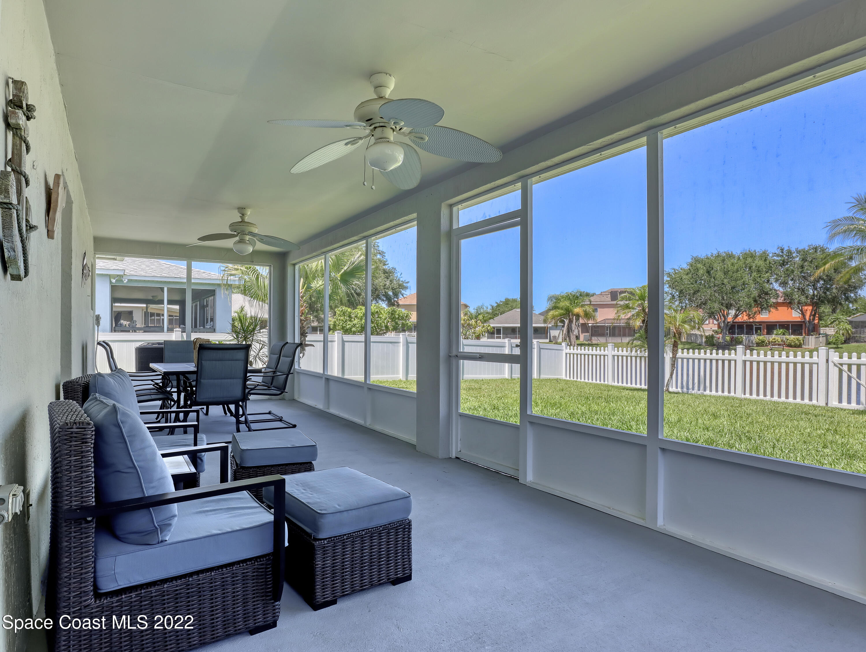4920 Spinet Drive Melbourne, FL 32940 - Photo 4 of 44 a living room with furniture and a floor to ceiling window