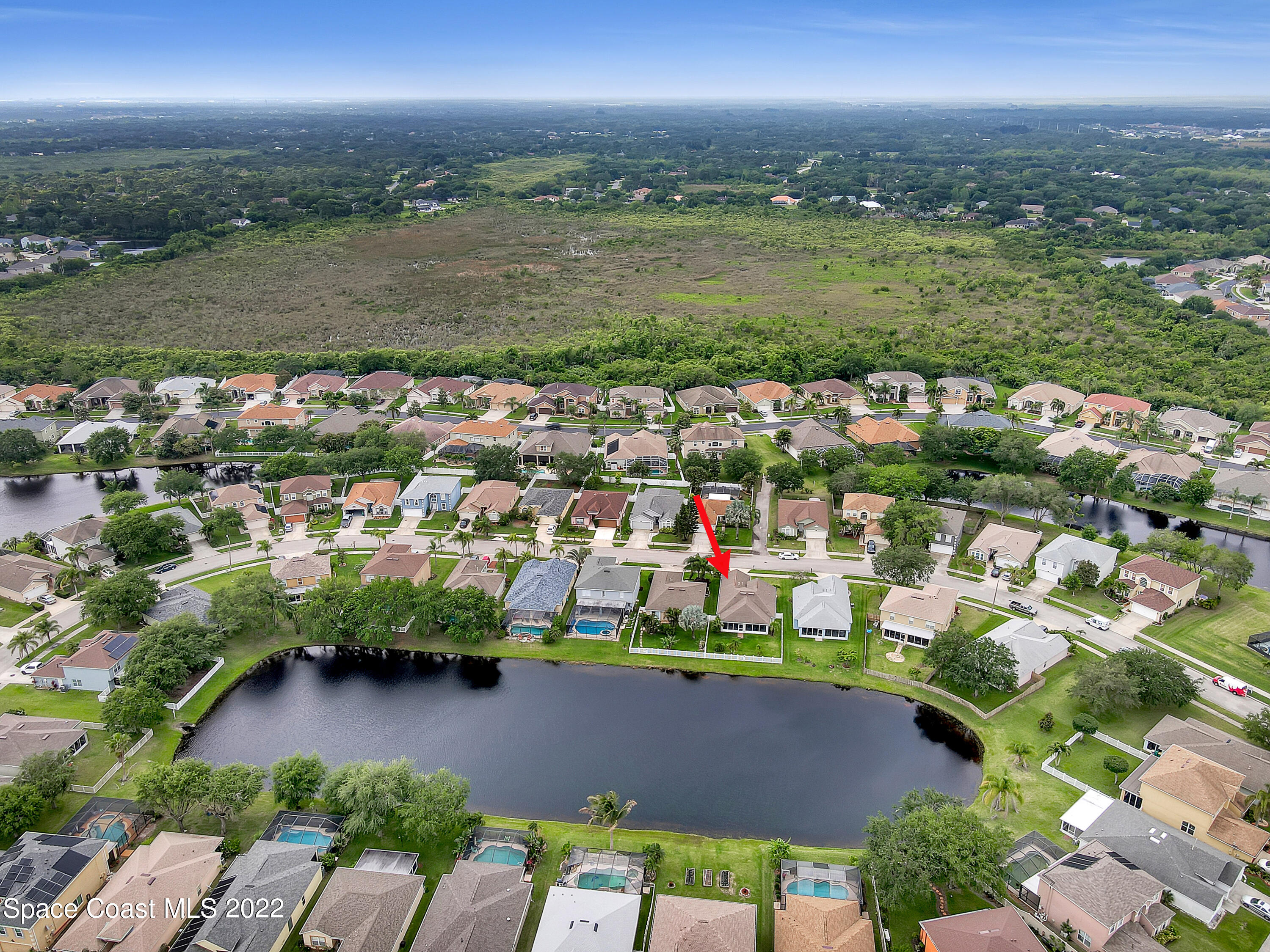 4920 Spinet Drive Melbourne, FL 32940 - Photo 43 of 44 an aerial view of a houses with a lake view