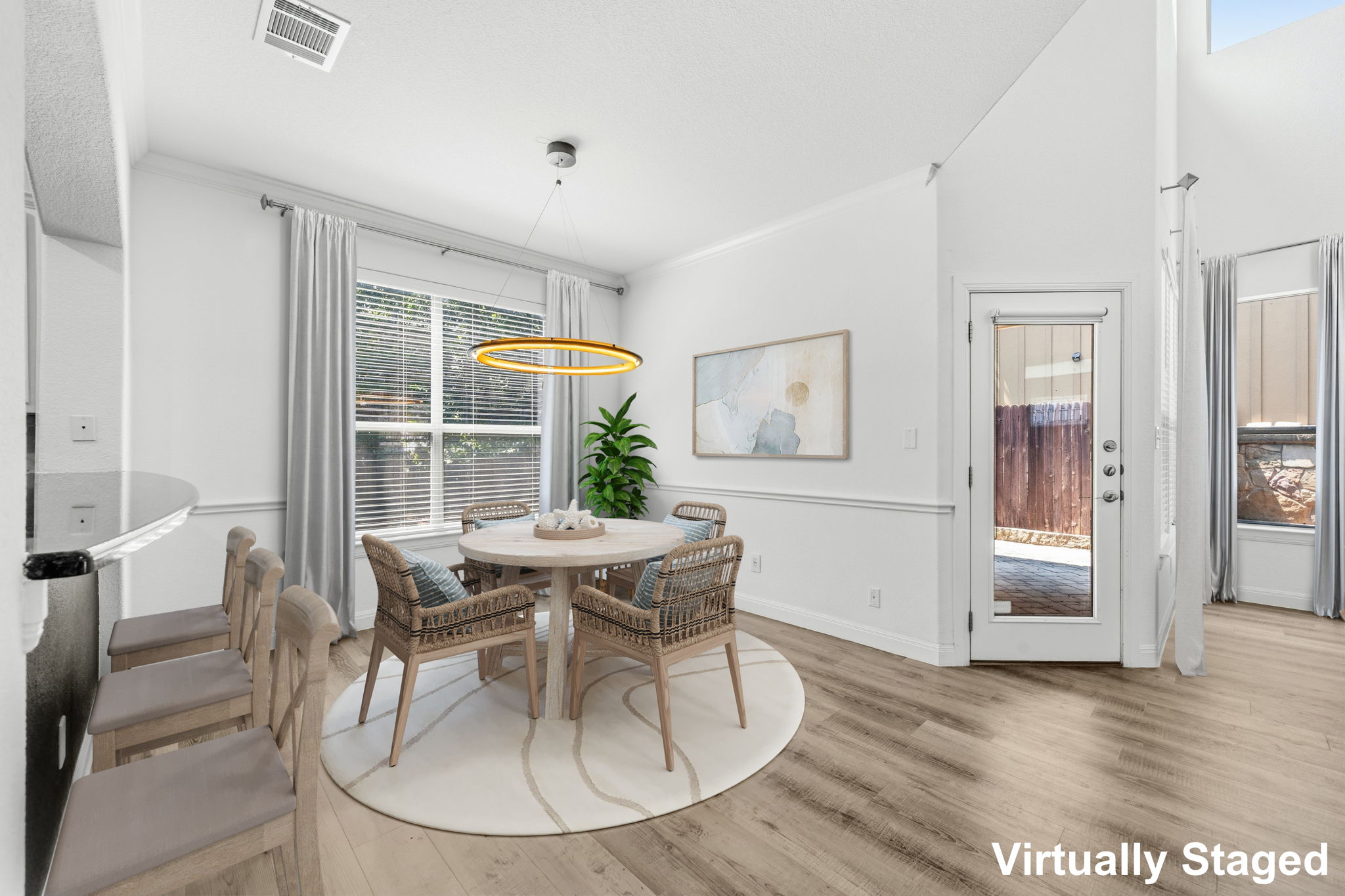 6708 Manchaca Road, Unit 4 Austin, TX 78745 - Photo 7 of 25 Gleaming wood floors and an elegant chair rail define this airy dining area.