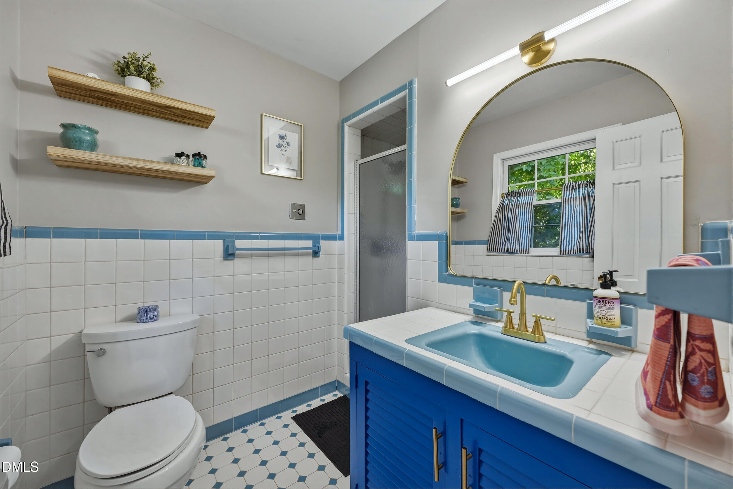 3726 Swift Drive Raleigh, NC 27606 - Photo 21 of 40 a bathroom with a toilet sink and mirror