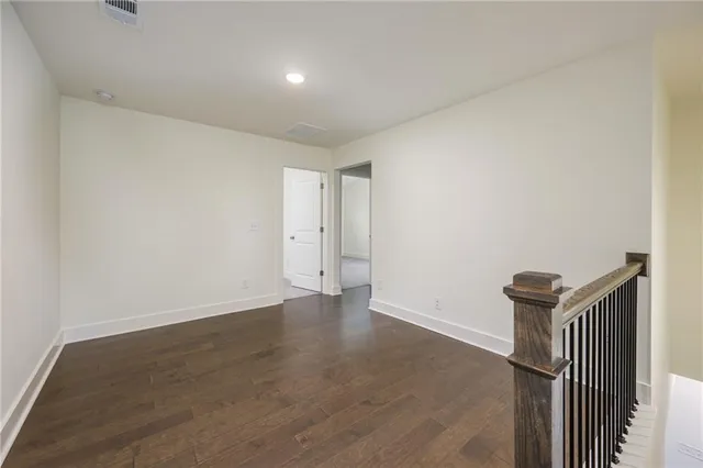 an empty room with wooden floor and a window