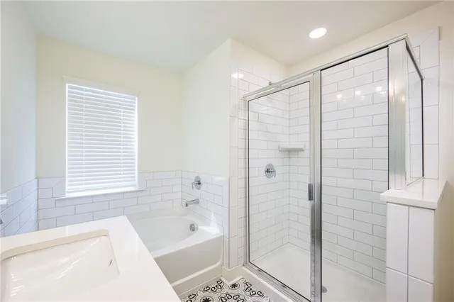 a bathroom with a bathtub shower and a sink
