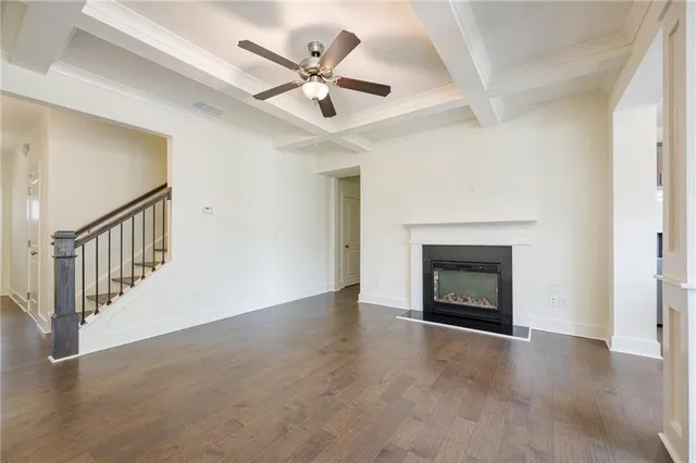an empty room with windows and fireplace