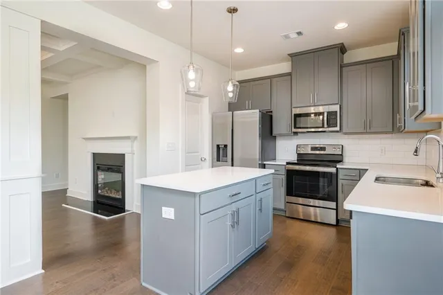 a kitchen with a sink stainless steel appliances and cabinets