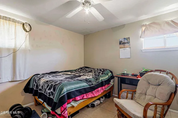 a bedroom with a bed and a chair