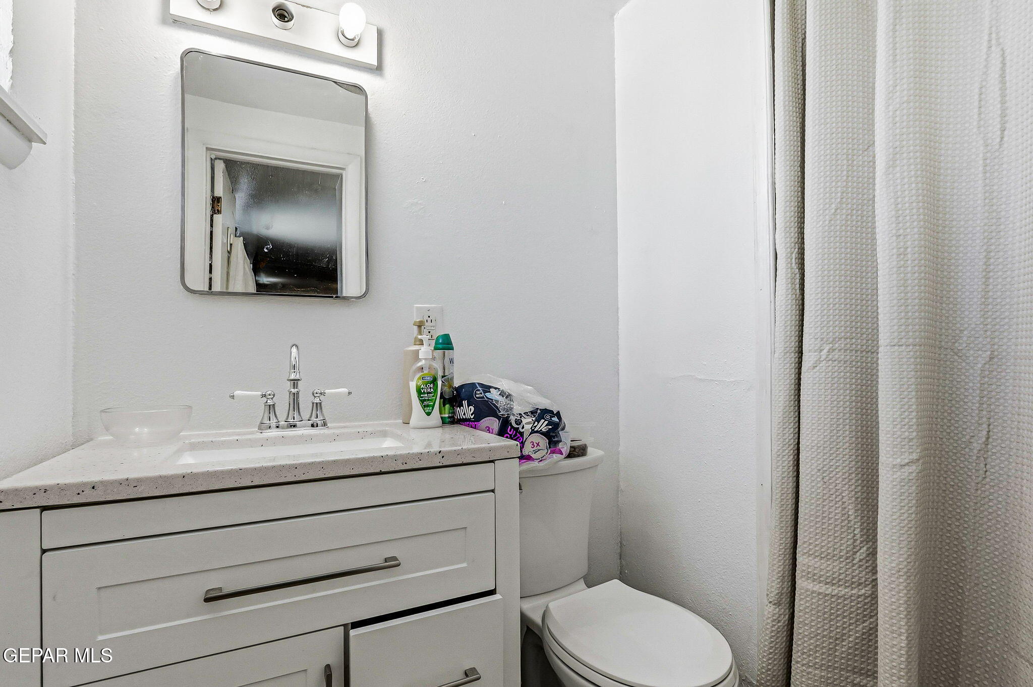 501 South 8th Street Anthony, TX 79821 - Photo 17 of 37 a bathroom with a toilet sink and mirror