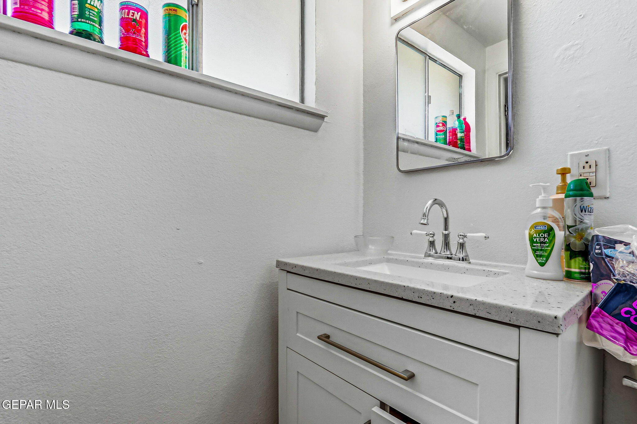 501 South 8th Street Anthony, TX 79821 - Photo 18 of 37 a bathroom with a granite countertop sink and a mirror