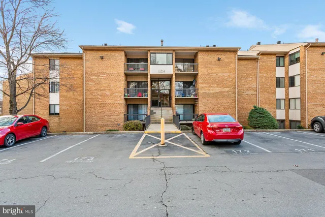 a view of a car is parked in front of a building