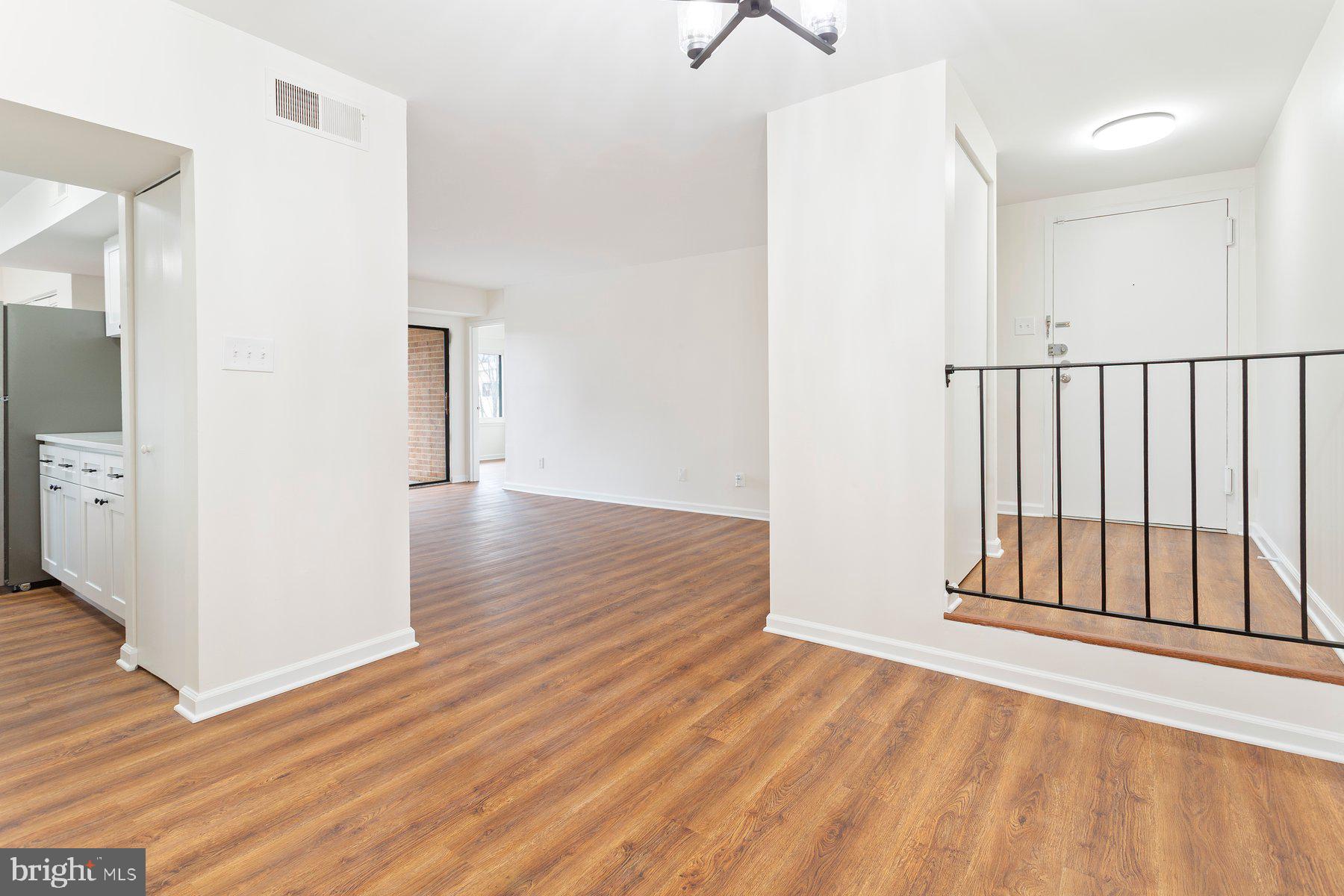 11234 Cherry Hill Road, Unit 304 Beltsville, MD 20705 - Photo 12 of 28 an empty room with wooden floor and windows