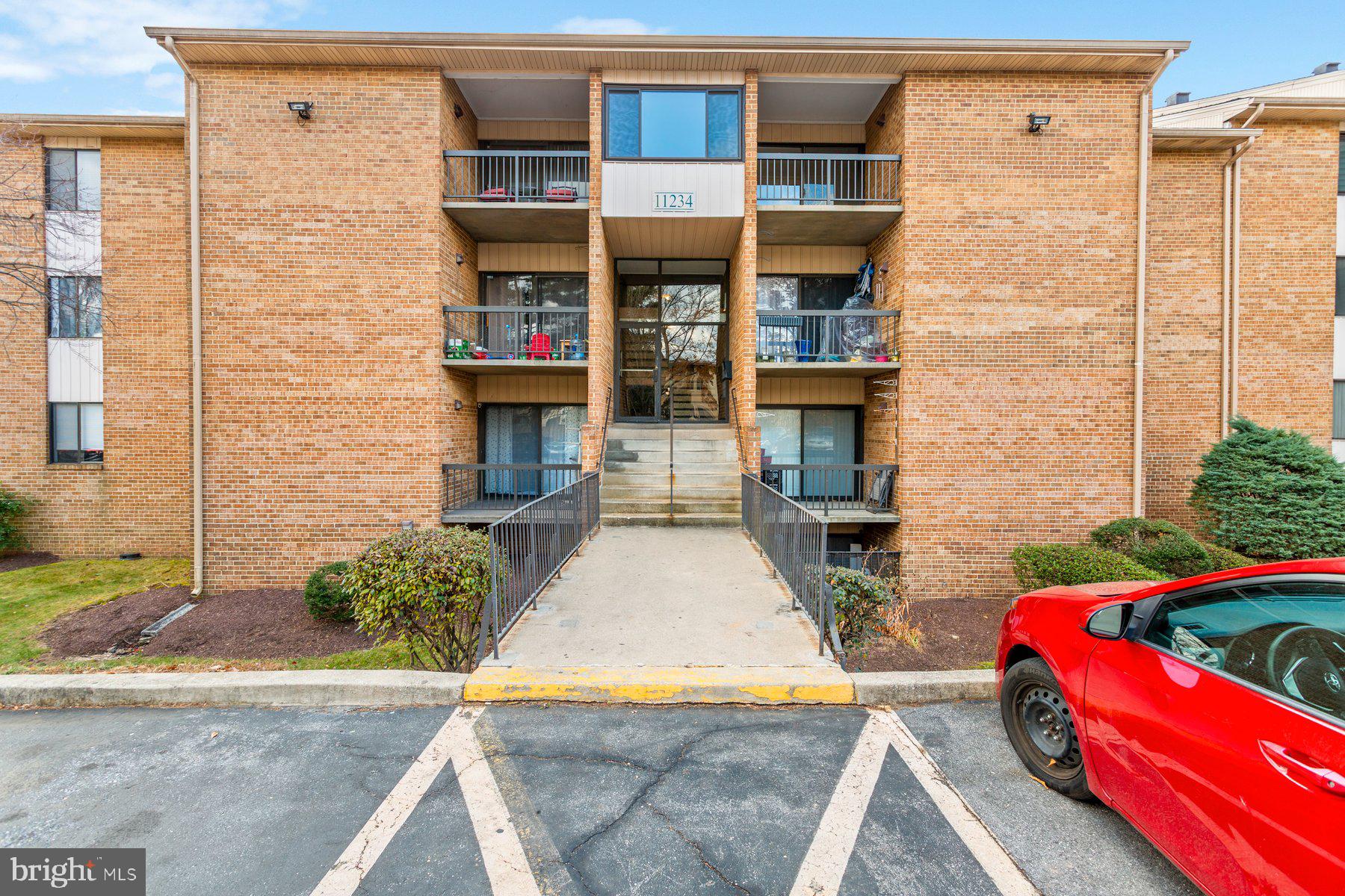 11234 Cherry Hill Road, Unit 304 Beltsville, MD 20705 - Photo 2 of 28 a front view of a house with a yard