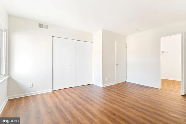 an empty room with wooden floor