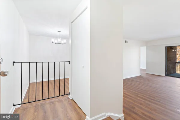 a view of a room with wooden floor