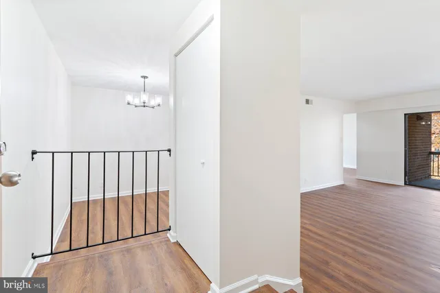 a view of a room with wooden floor