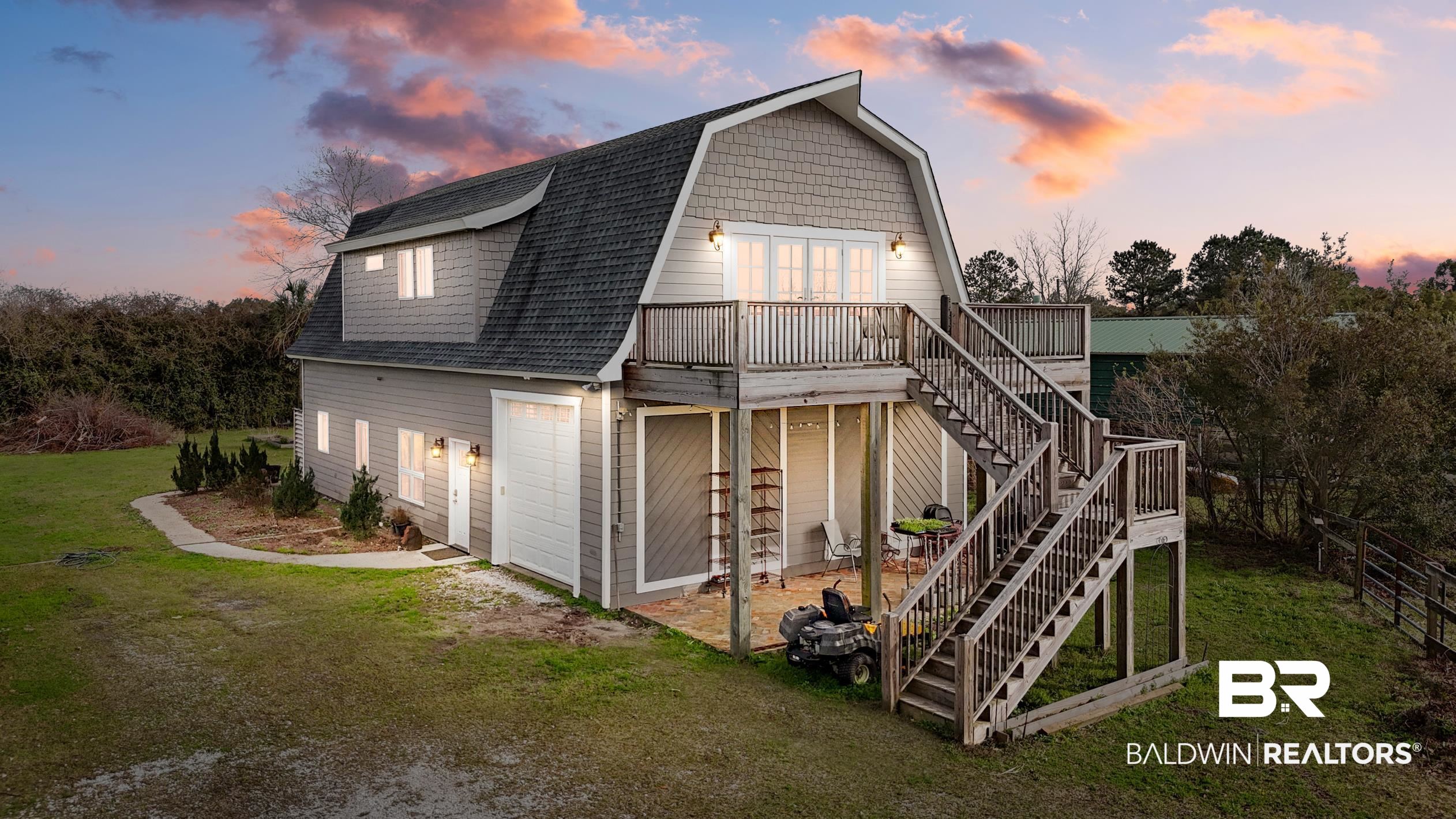 13358 County Road 91 Elberta, AL 36530 - Photo 1 of 47 Back house at dusk with a garage, a deck, and a lawn