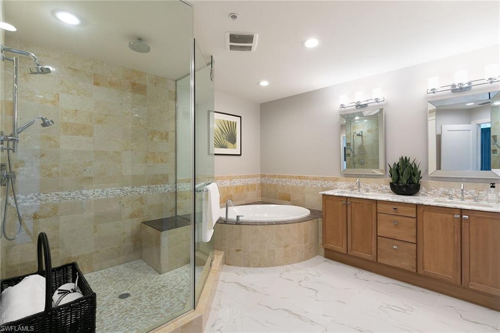 9123 Strada Place, Unit 7510 Naples, FL 34108 - Photo 15 of 38 Full bath with double vanity, a garden tub, a stall shower, and recessed lighting