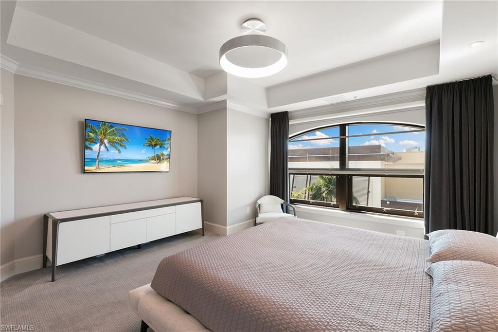 9123 Strada Place, Unit 7510 Naples, FL 34108 - Photo 15 of 38 Carpeted bedroom featuring a raised ceiling and ornamental molding