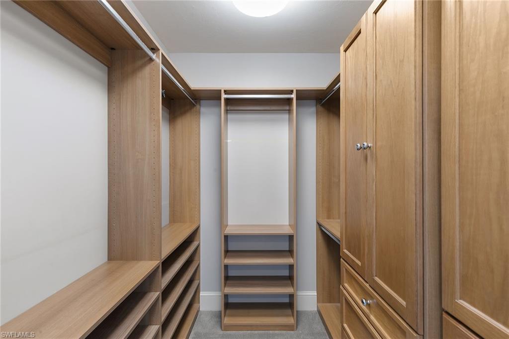 9123 Strada Place, Unit 7510 Naples, FL 34108 - Photo 18 of 38 Walk in closet with dark colored carpet