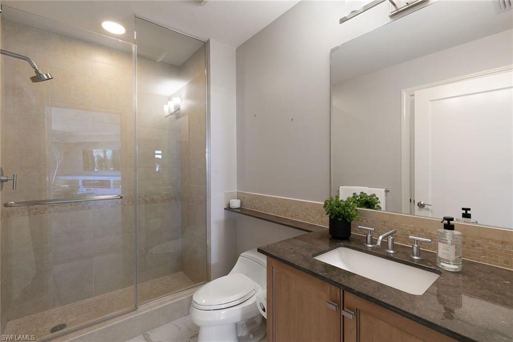 9123 Strada Place, Unit 7510 Naples, FL 34108 - Photo 22 of 38 Bathroom with vanity and a shower stall