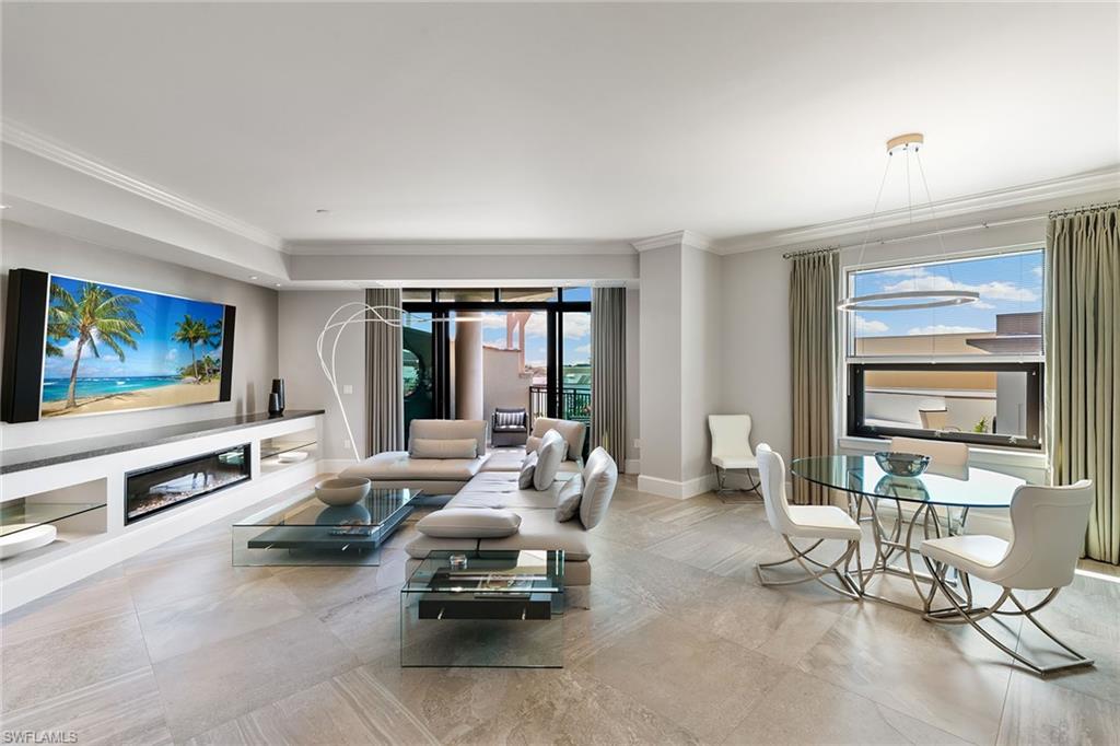 9123 Strada Place, Unit 7510 Naples, FL 34108 - Photo 3 of 38 Living room featuring ornamental molding and a glass covered fireplace
