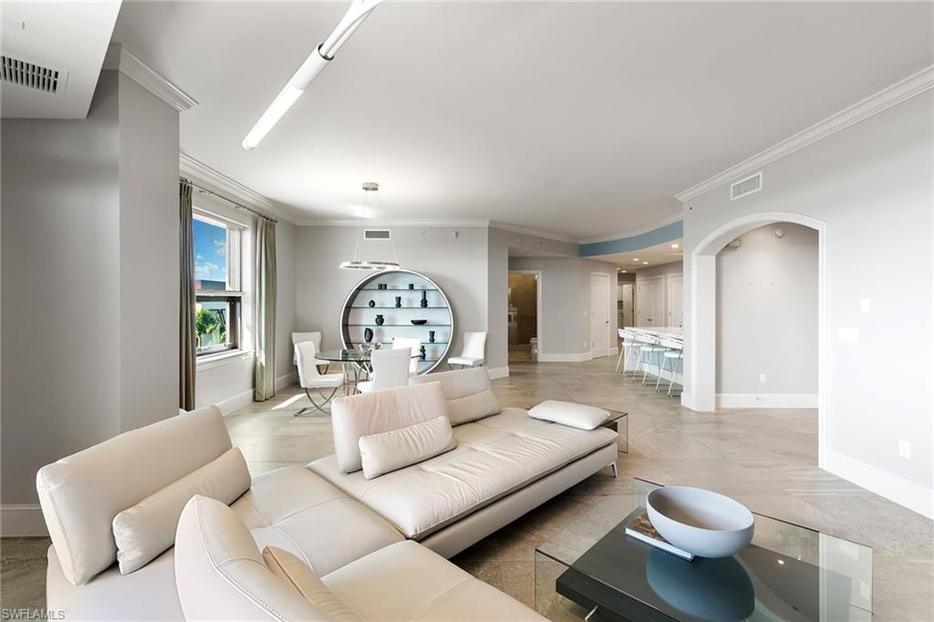 9123 Strada Place, Unit 7510 Naples, FL 34108 - Photo 36 of 38 Living area with crown molding and arched walkways