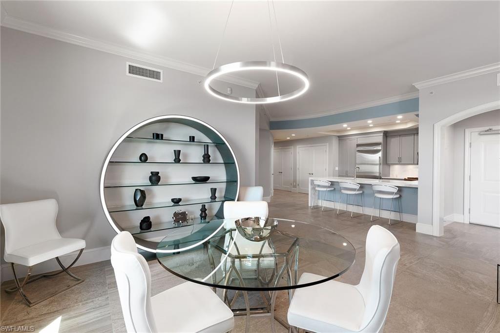 9123 Strada Place, Unit 7510 Naples, FL 34108 - Photo 6 of 38 Dining space with crown molding and arched walkways