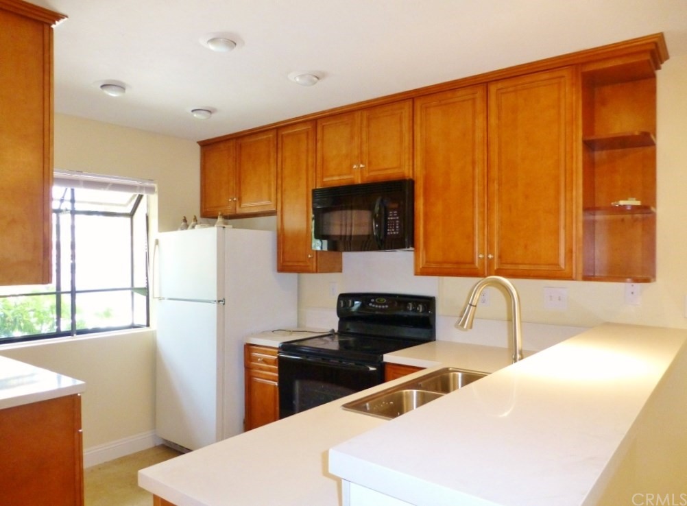 223 Pineview Irvine, CA 92620 - Photo 1 of 1 a kitchen with a sink a stove and a refrigerator