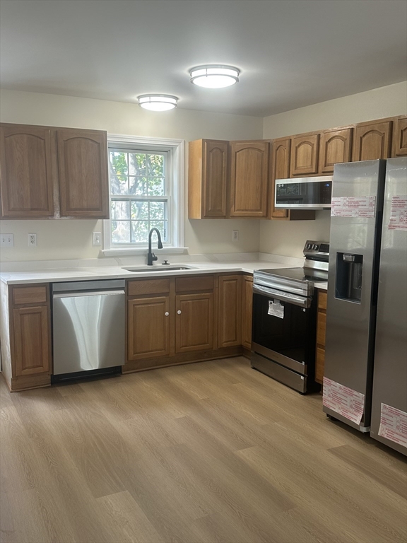 33 Denmark Street, Unit 33 Worcester, MA 01605 - Photo 3 of 10 a kitchen with stainless steel appliances granite countertop a refrigerator a sink a stove a microwave and island