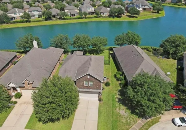 an aerial view of a house with a lake view