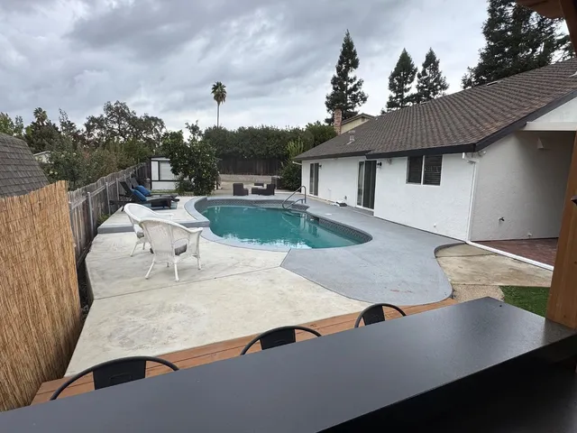 a roof deck with table and chairs