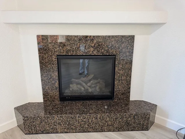 a stone fireplace with a fireplace