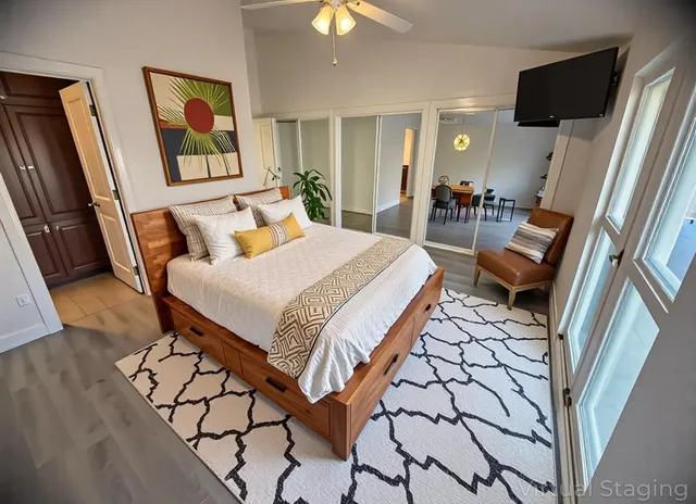 a bedroom with a bed and flat screen tv