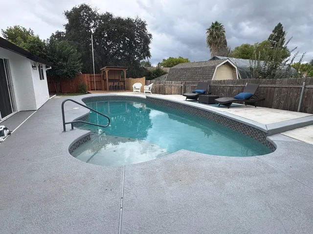 a view of a swimming pool with a yard