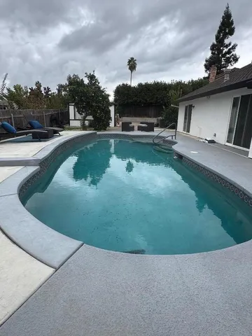 a view of a swimming pool with a yard