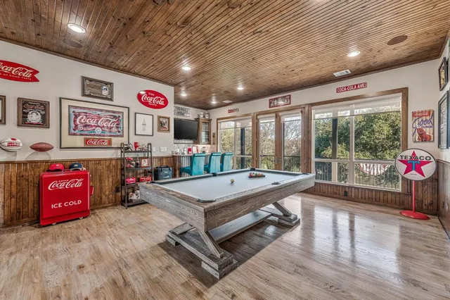 a room with pool table and flat screen tv