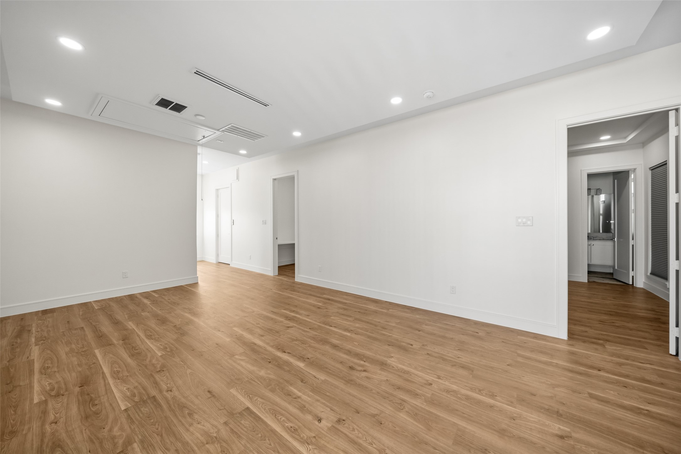 1839 Colquitt Street Houston, TX 77098 - Photo 14 of 19 Alternate view of living room with wood flooring and white walls.