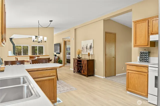 a view of a kitchen with a sink dishwasher kitchen stove and cabinets