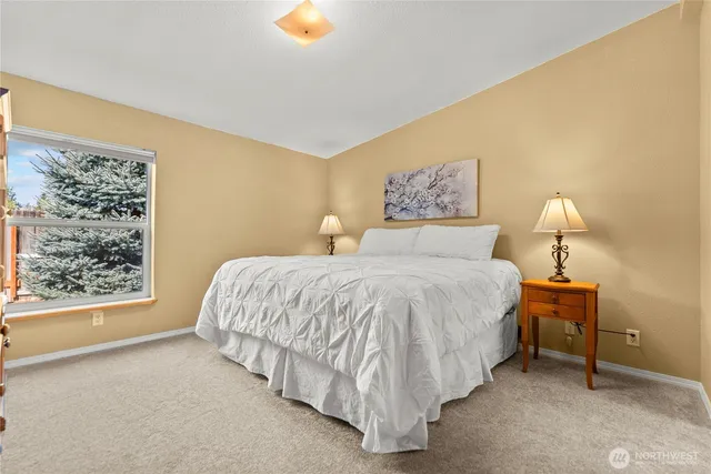 a spacious bedroom with a bed and a window