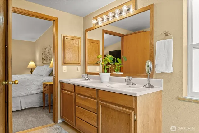 a spacious bathroom with a double vanity sink and a mirror