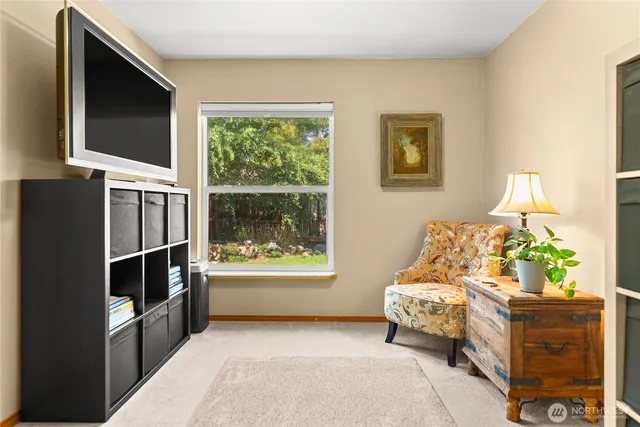 a bedroom with furniture and a flat screen tv