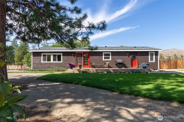 a view of a house with a backyard porch and sitting area
