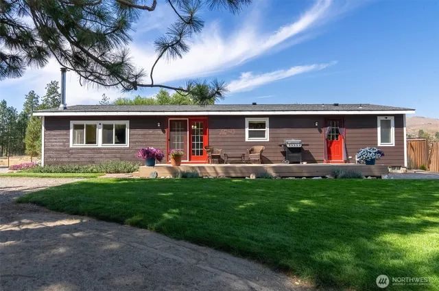 a front view of house with yard and outdoor seating