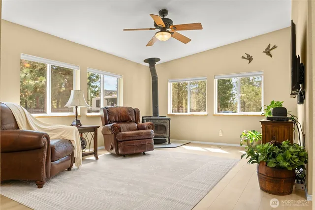 a living room with furniture chandelier and a large window