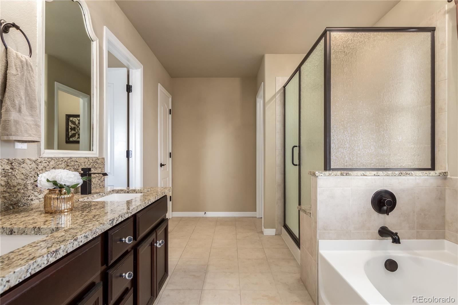 24389 East Brandt Avenue Aurora, CO 80016 - Photo 22 of 49 a bathroom with a granite countertop sink and a mirror